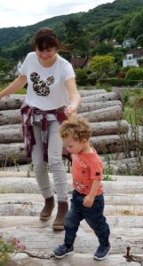 Porlock Weir Beach family playing on the logs