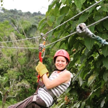 Lady ziplining through Dominican Republic jungle