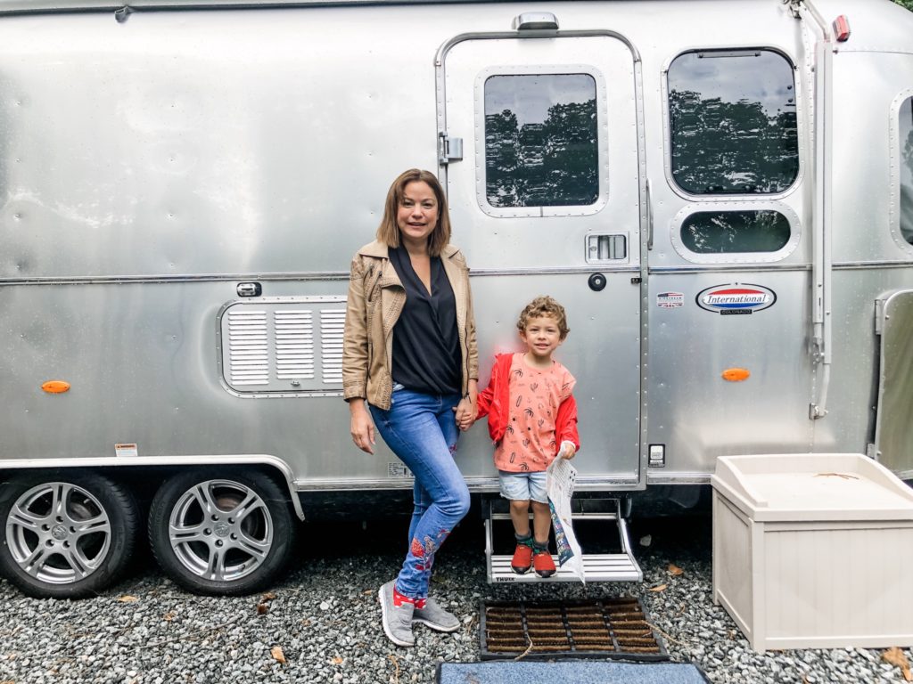 Mum and son by airstream caravan