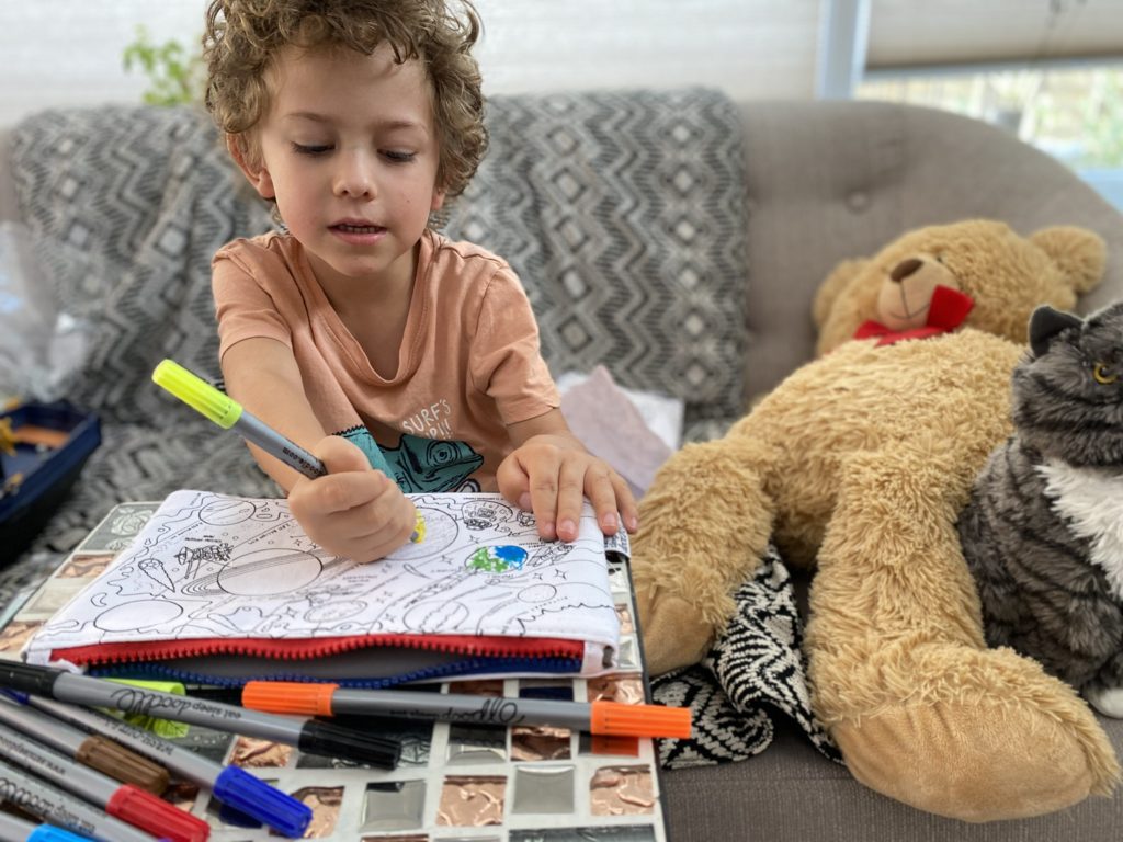 boy colouring in his space pencil case from eat sleep doodle