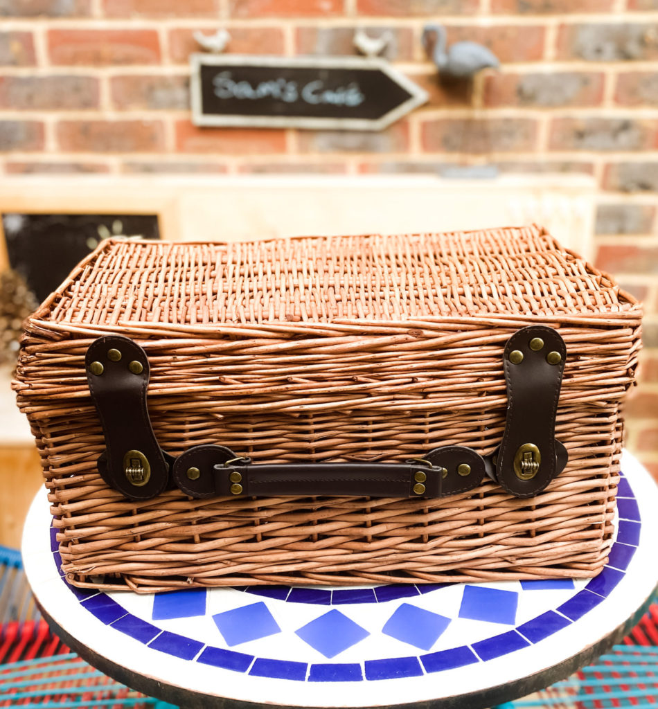 Handmade wicker basket from Prestige Hampers on patio table