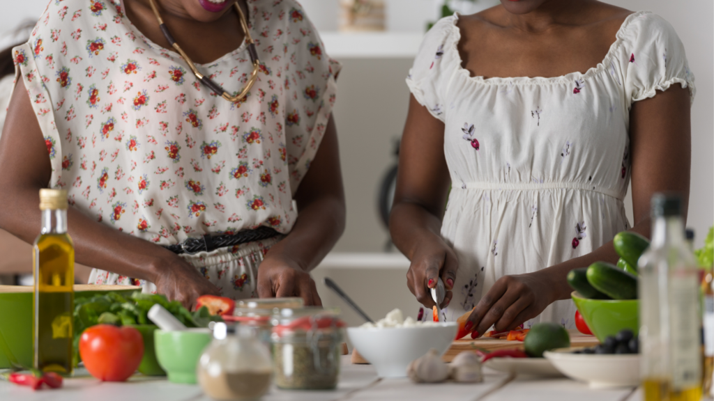 Two ladies cooking together at cooking class