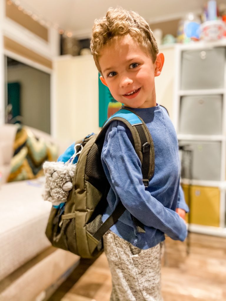 Boy with rucksack with sharkie the day dreamimal key chain and kids hand sanitiser