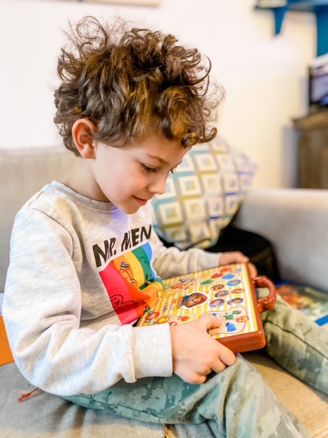 Preschool boy playing with Paddington Learning Suitcase