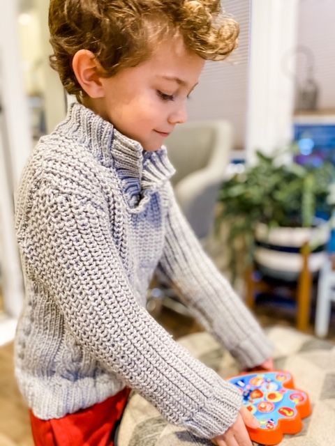 four year old boy playing with Paddington Paw Pad