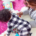 Mum and crawling baby playing on the floor