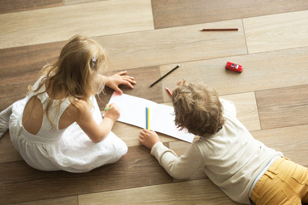 children colouring in on vinyl floor