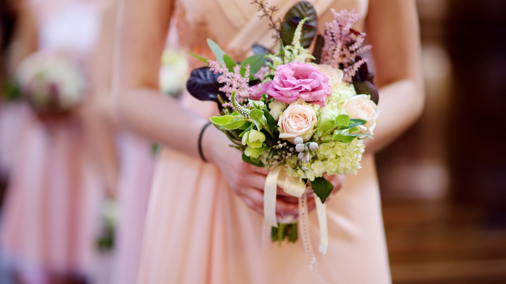 Bridesmaid dress with bridesmaid holding bouquet of flowers