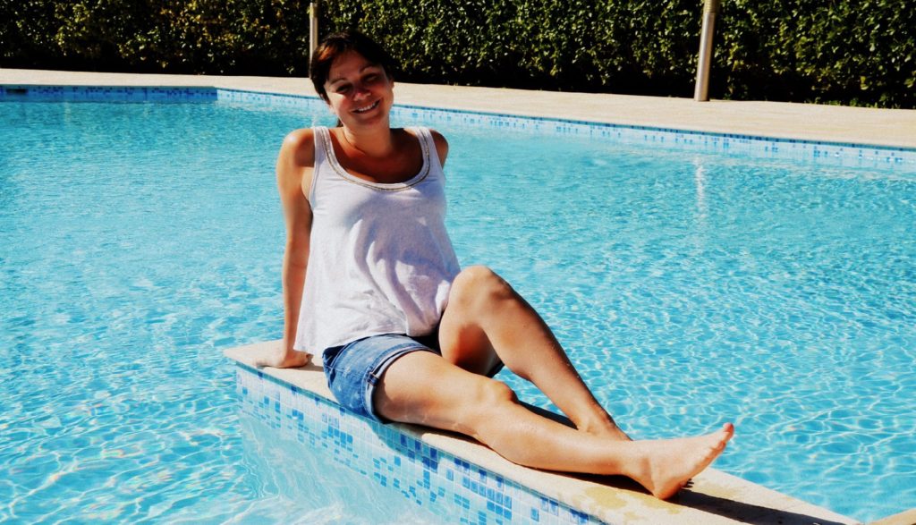 Lady sunbathing by the pool in Cyprus in February