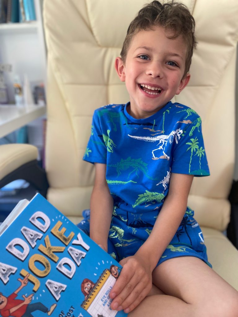 Boy laughing at a dad joke a day