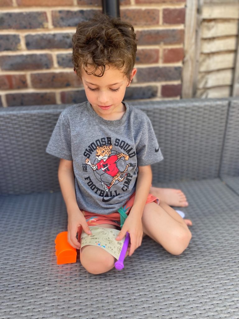 Boy playing with free gift from Hey Duggee