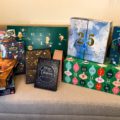 Christmas Advent Calendars 2021 piled up on a sofa