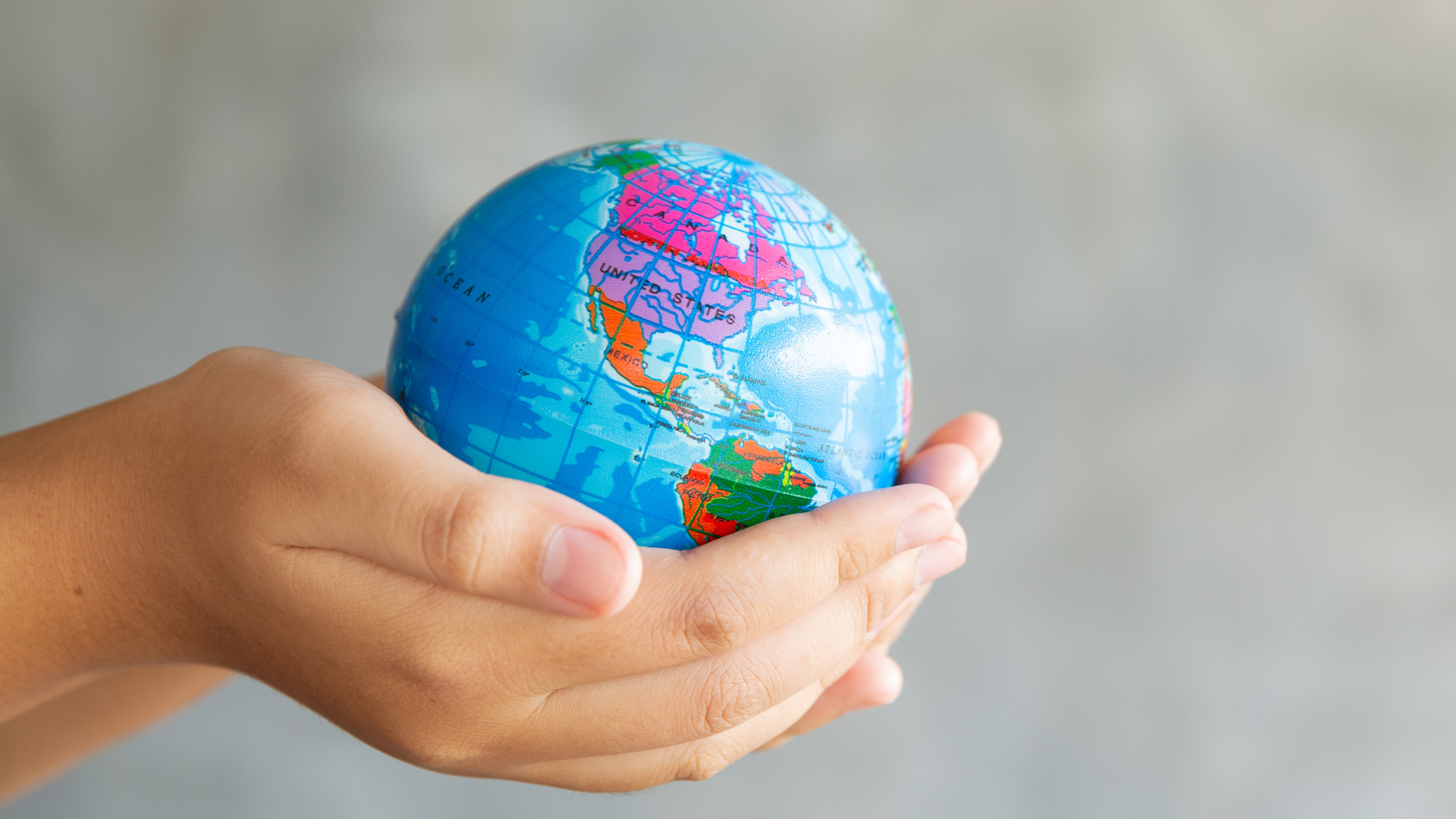 Woman's hands holding the world in her hands