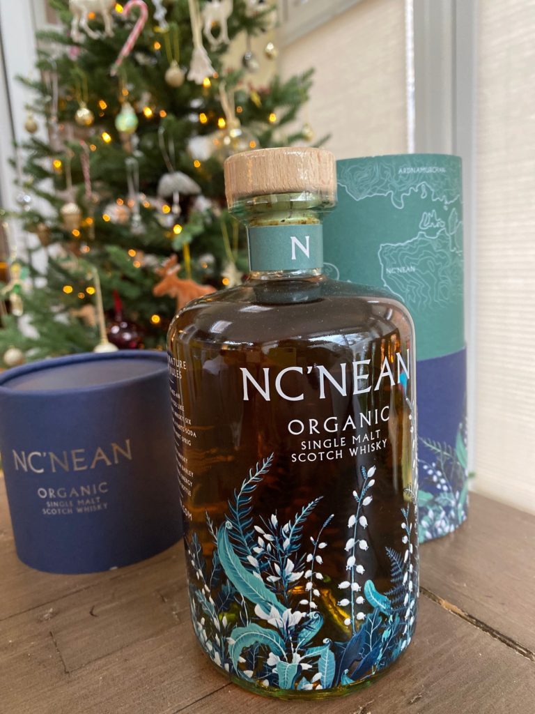 Bottle of McNean whisky by christmas tree