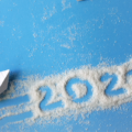Travel Trends for 2022 blog banner with picture of paper boat and paper airplane with 2022 written in sand