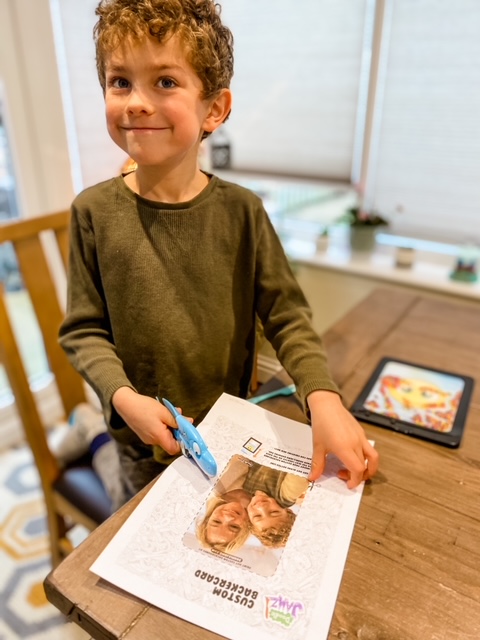 Boy cuting out image to put in his Doodlejamz
