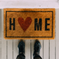 Home doormat with a heart for the o in home