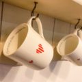 2 fine bone china mugs with hearts design hanging on a dresser