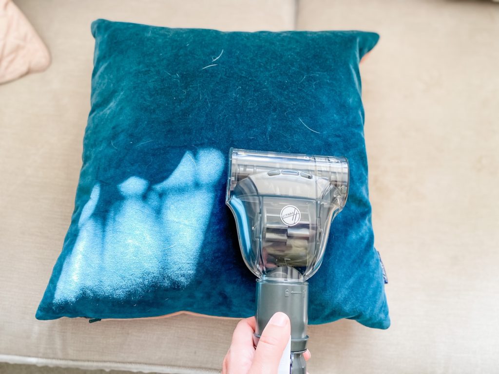 Pet brush from the hoover upright 300 being used on a cushion with dog hair