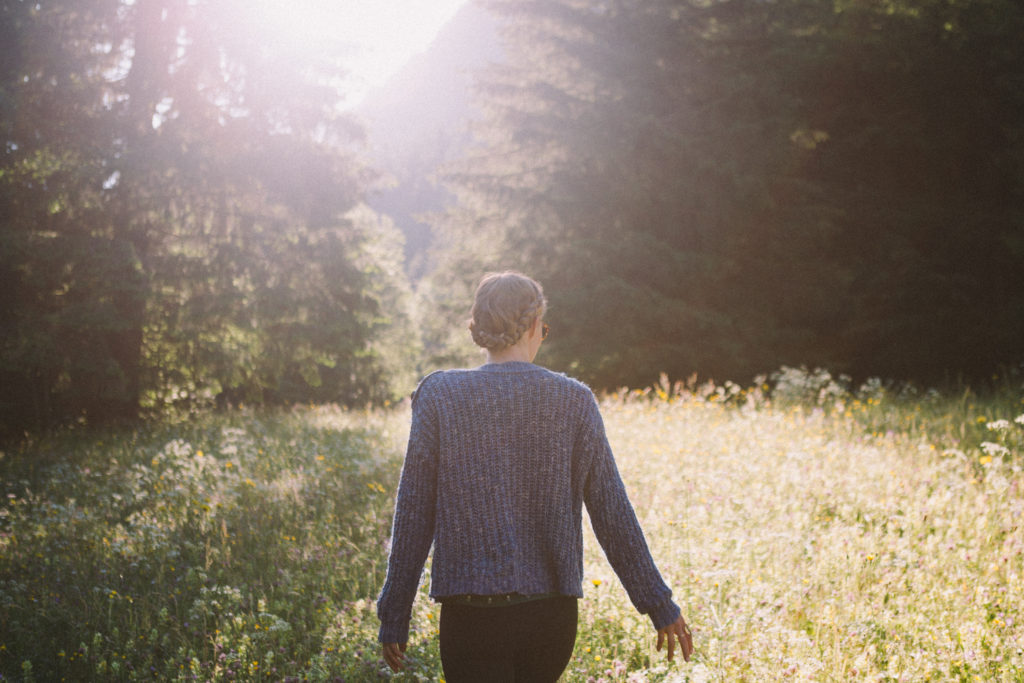 Lady walking in a sunny field
