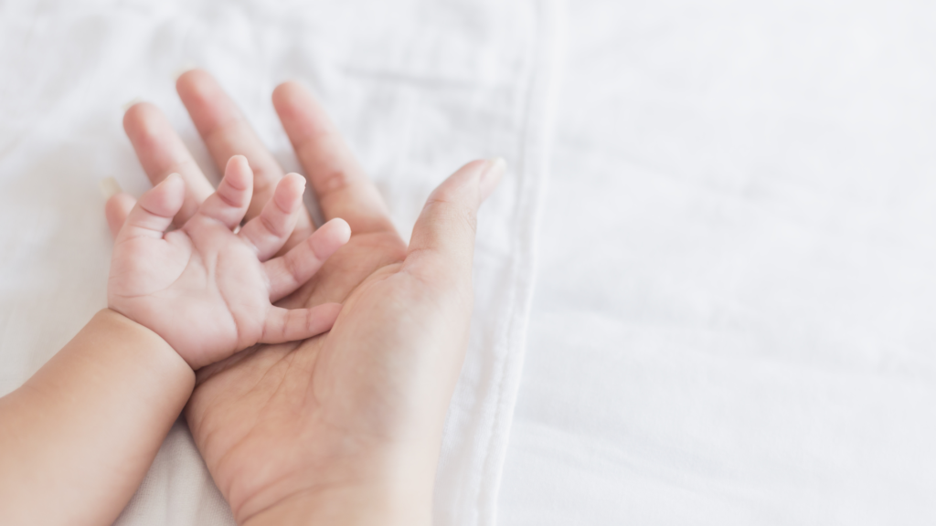 Baby and mums hand