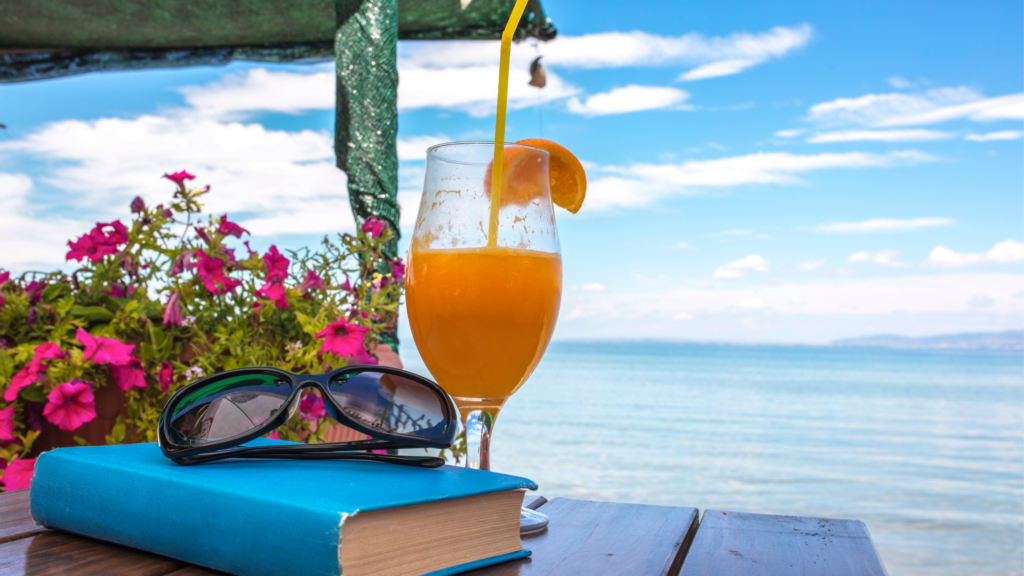 Orange juice on a table looking out to the sea