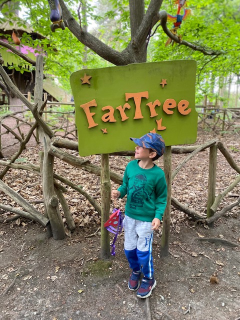 Boy by Far Tree sign at BeWILDerwood