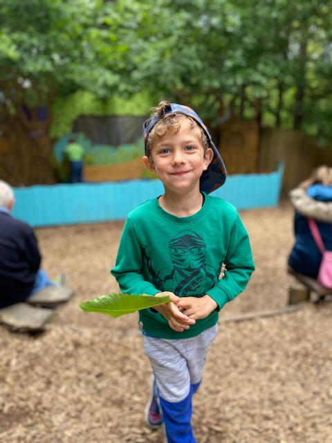 Boy waiting for the show to start at the story stage at BeWILDerwood
