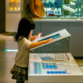 Little girl looking at an interactive screen in a science museum