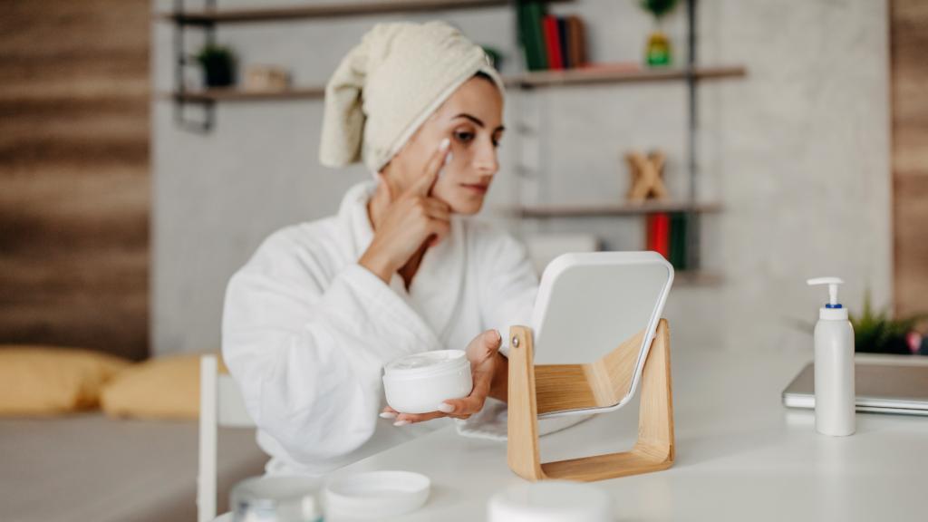 Lady getting ready at the kitchen table doing her morning beauty routine