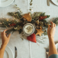 Woman's arms preparing christmas table decorations