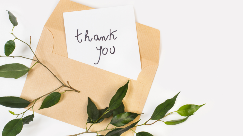 A little note by an envelope saying thank you