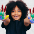 Happy kid with paint on their hands