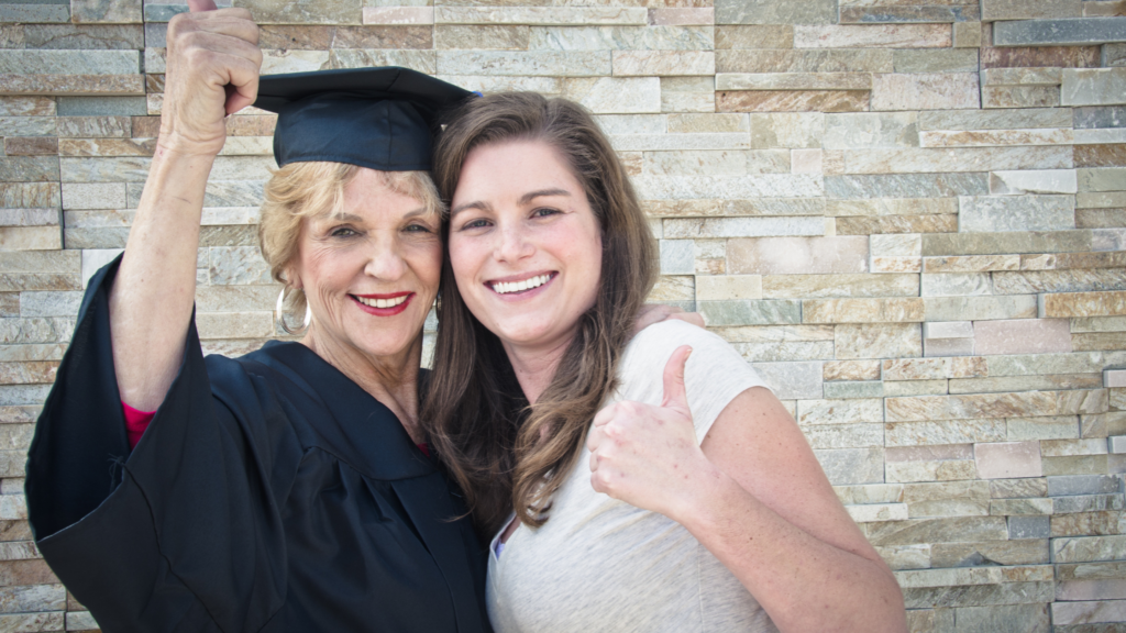 Mature student graduating from university with her daughter next to her