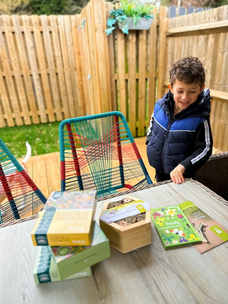 Boy looking at gardening goodies in the garden