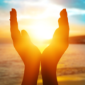 Two hands coming together to form a circle around the sun