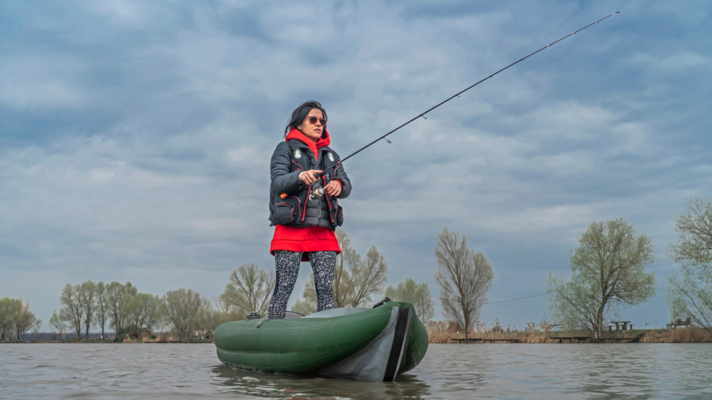 Lady fishing on a boat on a lake