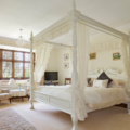 White four poster bed in white bedroom