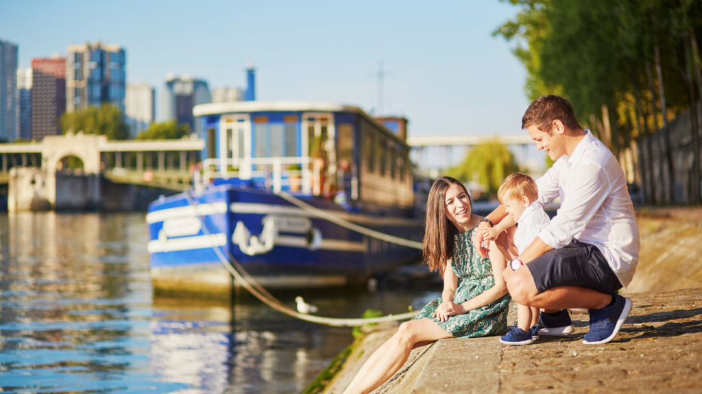 Family sitting by the Seine in Paris