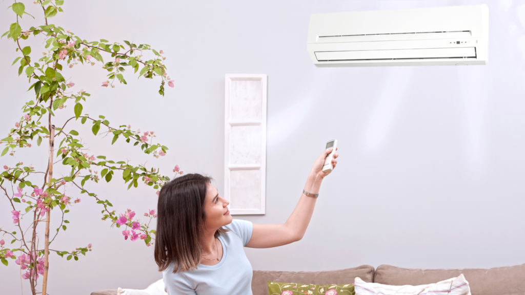Lady with air conditioner sitting down at home