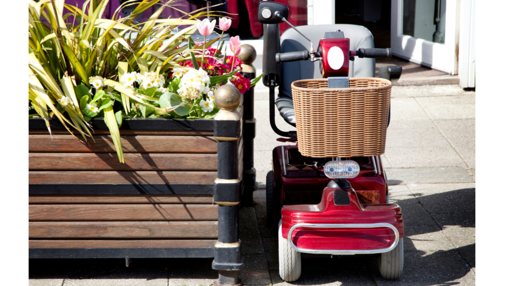 Red mobility scooter next to plants
