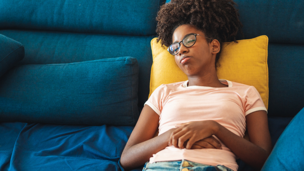 Teenage girl asleep on sofa