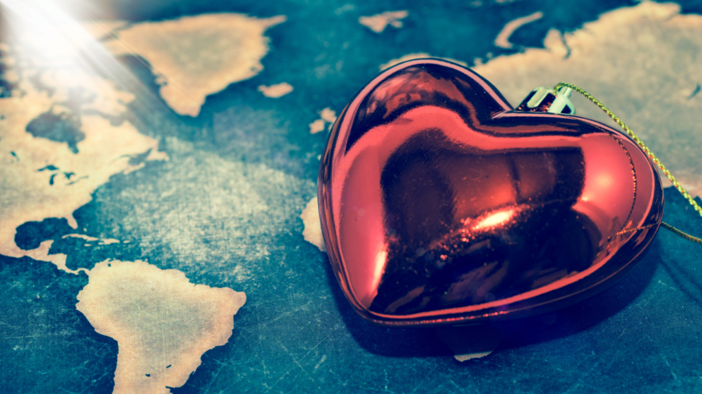 A map with a Christmas heart bauble on top of it