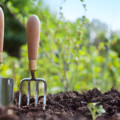 Gardening tools in soil in the garden