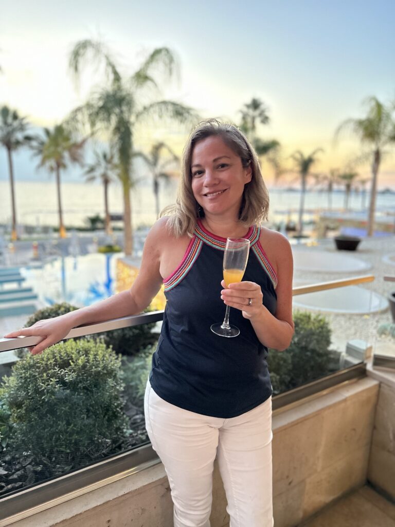 Lady enjoying a drink at Alexander the great beach hotel in cyprus