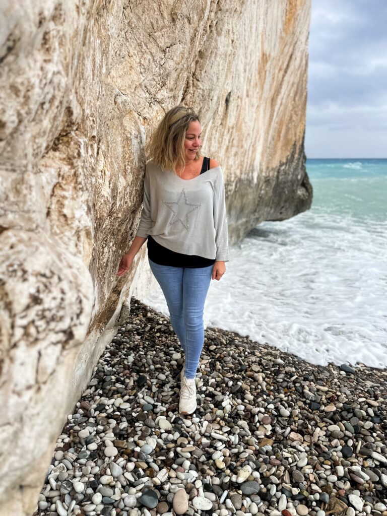 Lady leaning against aphrodites rock