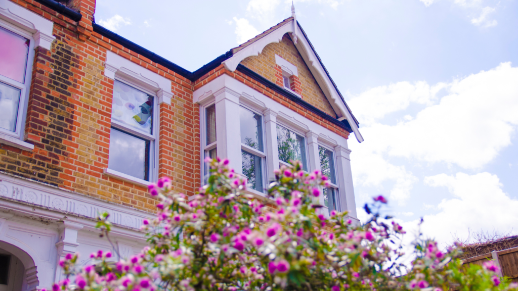 Front of a UK home with pink flowers at the front