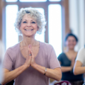 Ladies doing yoga in a standing prayer pose