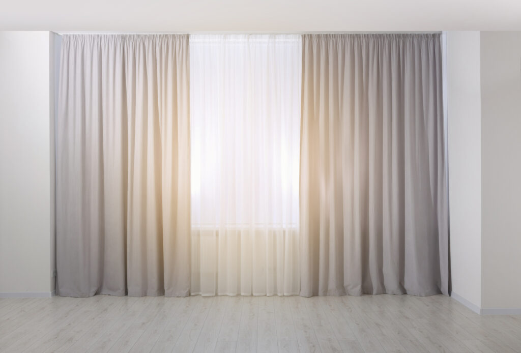 Light grey window curtains and white tulle indoors