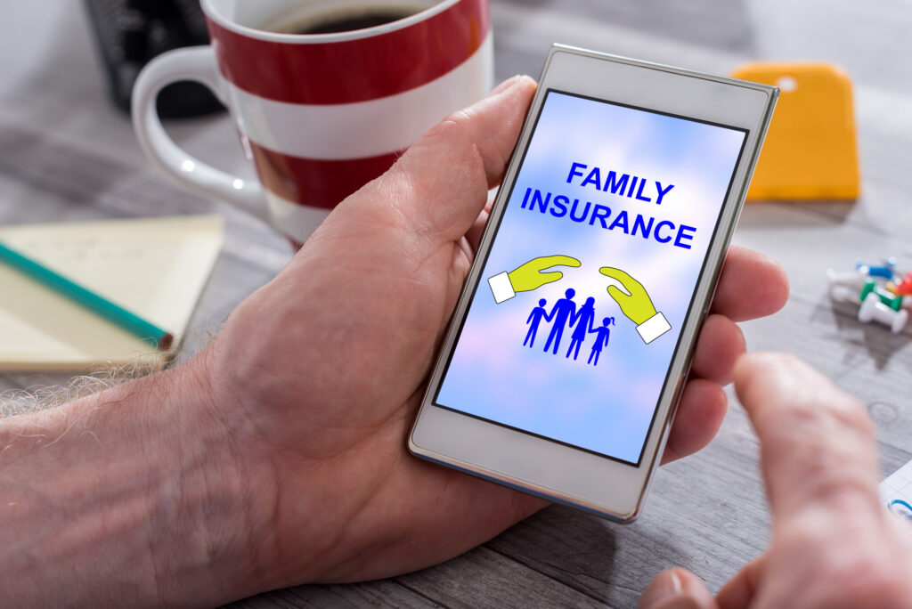 Male hand holding a smartphone with family protection concept